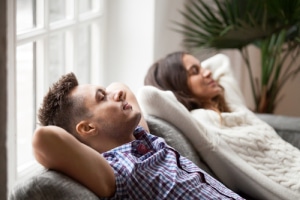 Happy couple on couch-7 reasons to get a furnace tune-up-Allgeier Air-Louisville-300x200