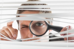 Man with magnifying glass- Why join our Maintenance Service Club -Allgeier Air-Louisville-300x200