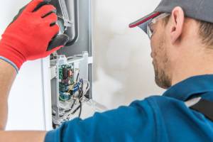 technician fixing furnace-Furnace repair Louisville-Allgeier Air-Louisville KY