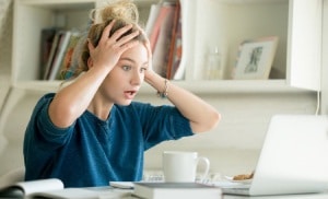 Lady stressed out looking at her bills on computer-15 Ways to Save on your Energy Bill Part 1-Allgeier Air-Louisville-300x182
