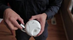 Man replacing batteries in smoke alarm-Allgeier Air-Louisville KY-300x167jpg