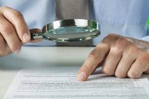 Looking at paperwork through a magnifying glass-The Ban Of R 22 Refrigerant-Allgeier Air-Louisville KY-300x200jpg