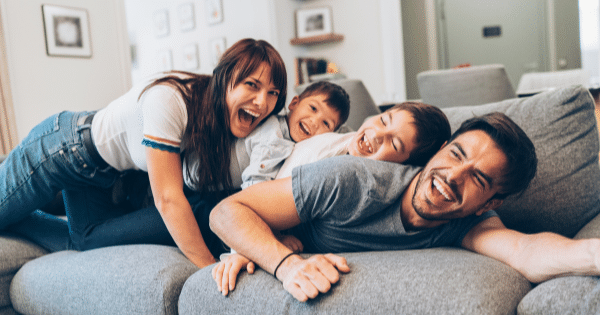 Happy family on couch-Save Money On A New AC And Furnace-Allgeier Air-Louisville KY-600x315jpg