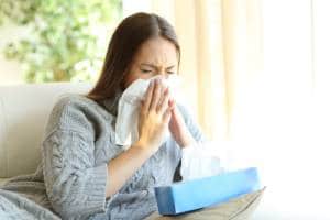 Lady blowing her nose-Benefits of a Humidifier-Allgeier Air-Louisville KY-300x200jpg