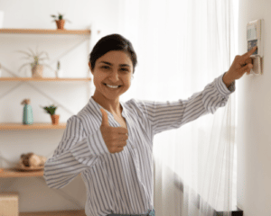 Lady using a smart thermostat- Money Saving Tips For The Summer-Allgeier Air-Louisville KY-500x400jpg 