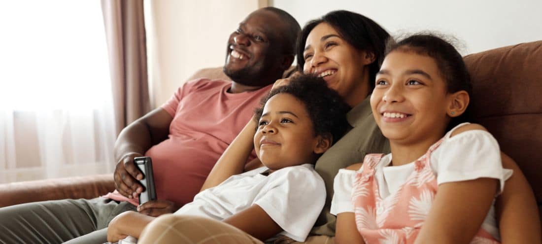 Family on couch-11 Secrets To Reduce Humidity And Avoid AC Repair-Allgeier Air-Louisville KY-1100x495jpg
