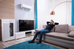 Man on couch with mini split unit-Where Can You Install A Mini Split Unit-Allgeier Air-Louisville KY-600x400jpg 