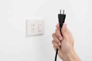 Unplugging a plug from wall-10 Hacks To Save Money On Your AC Bill-Allgeier Air-Louisville KY-600x400jpg