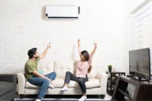 Couple on couch with mini split unit-Questions To Ask When Considering A New Air Conditioner-Allgeier Air-Louisville KY-600x400jpg 