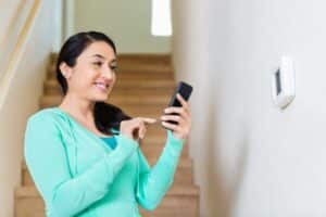 Lady with phone-Questions To Ask When Considering A New Air Conditioner-Allgeier Air-Louisville KY-600x400jpg 