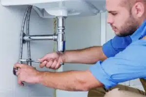 Plumber fixing pipes under sink-6 Common Pipe Issues-Allgeier Air-Louisville KY-600x400jpg 